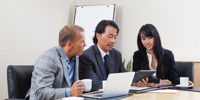 Business people using tablet in meeting
